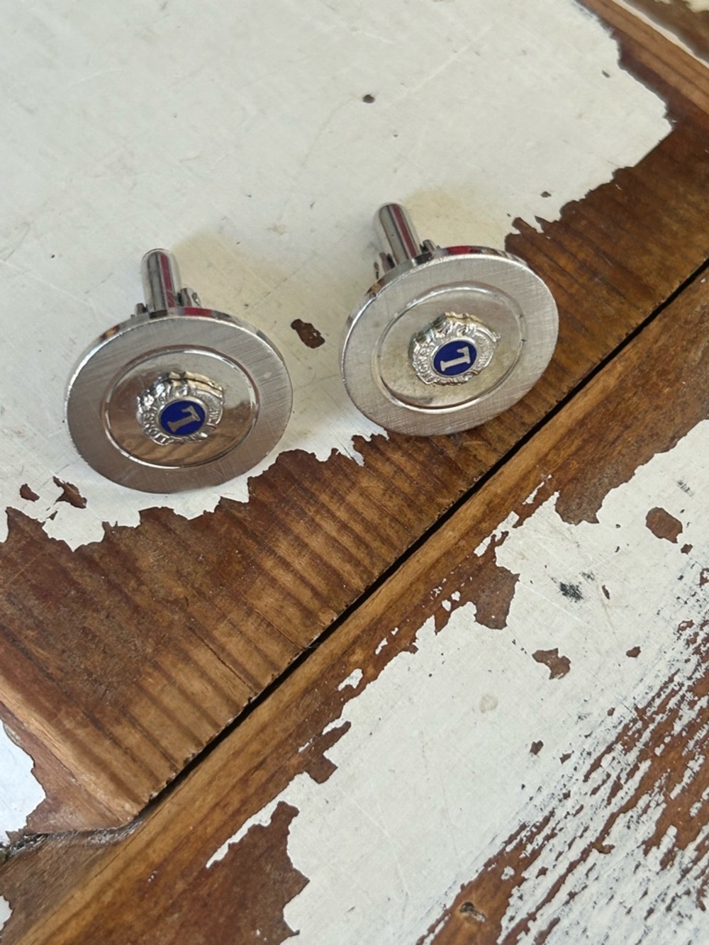 Vintage silver-tone cufflinks featuring the emblem of Lions Clubs International
